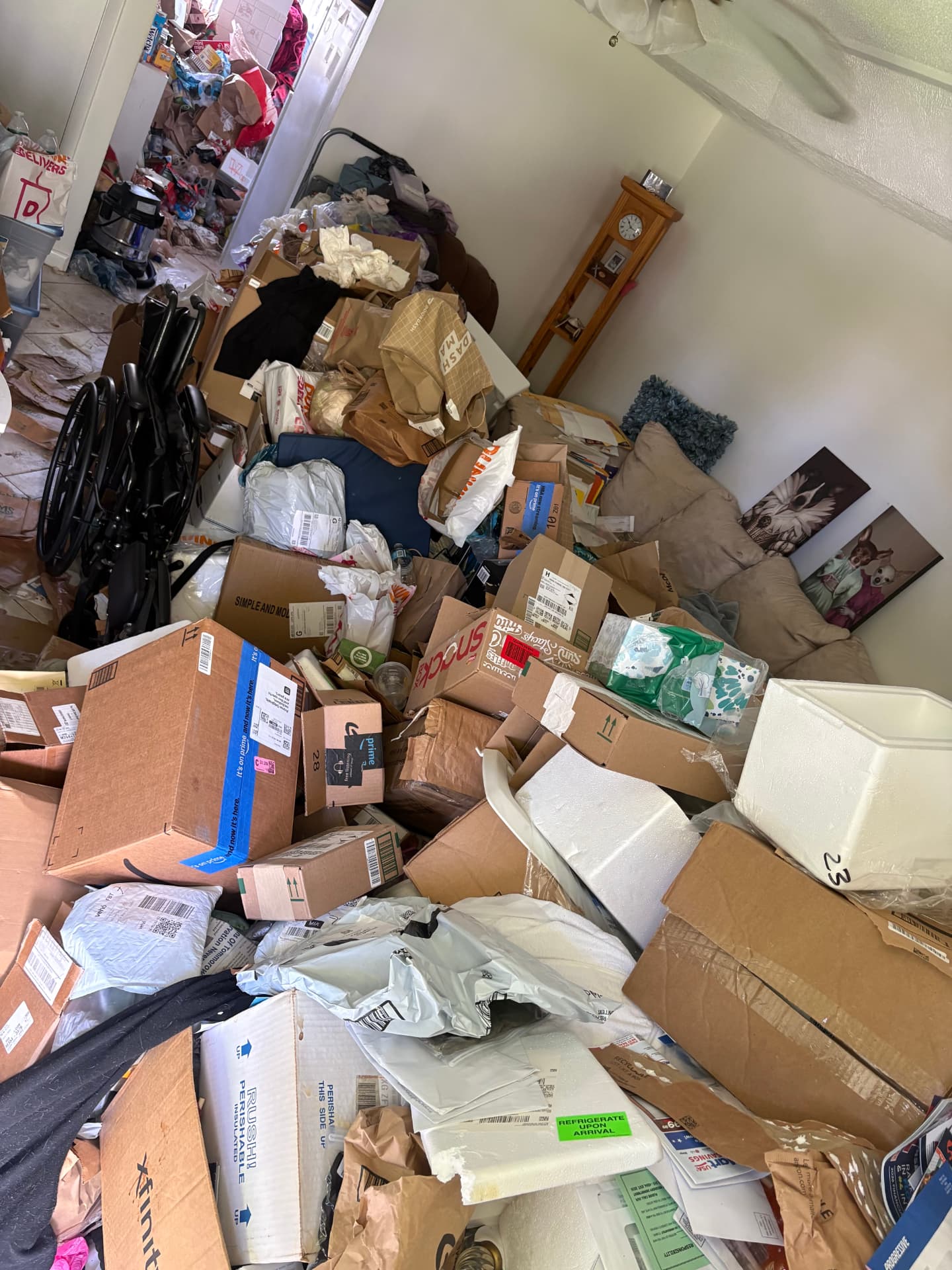 Room packed floor to ceiling with boxes and clutter before a full cleanout