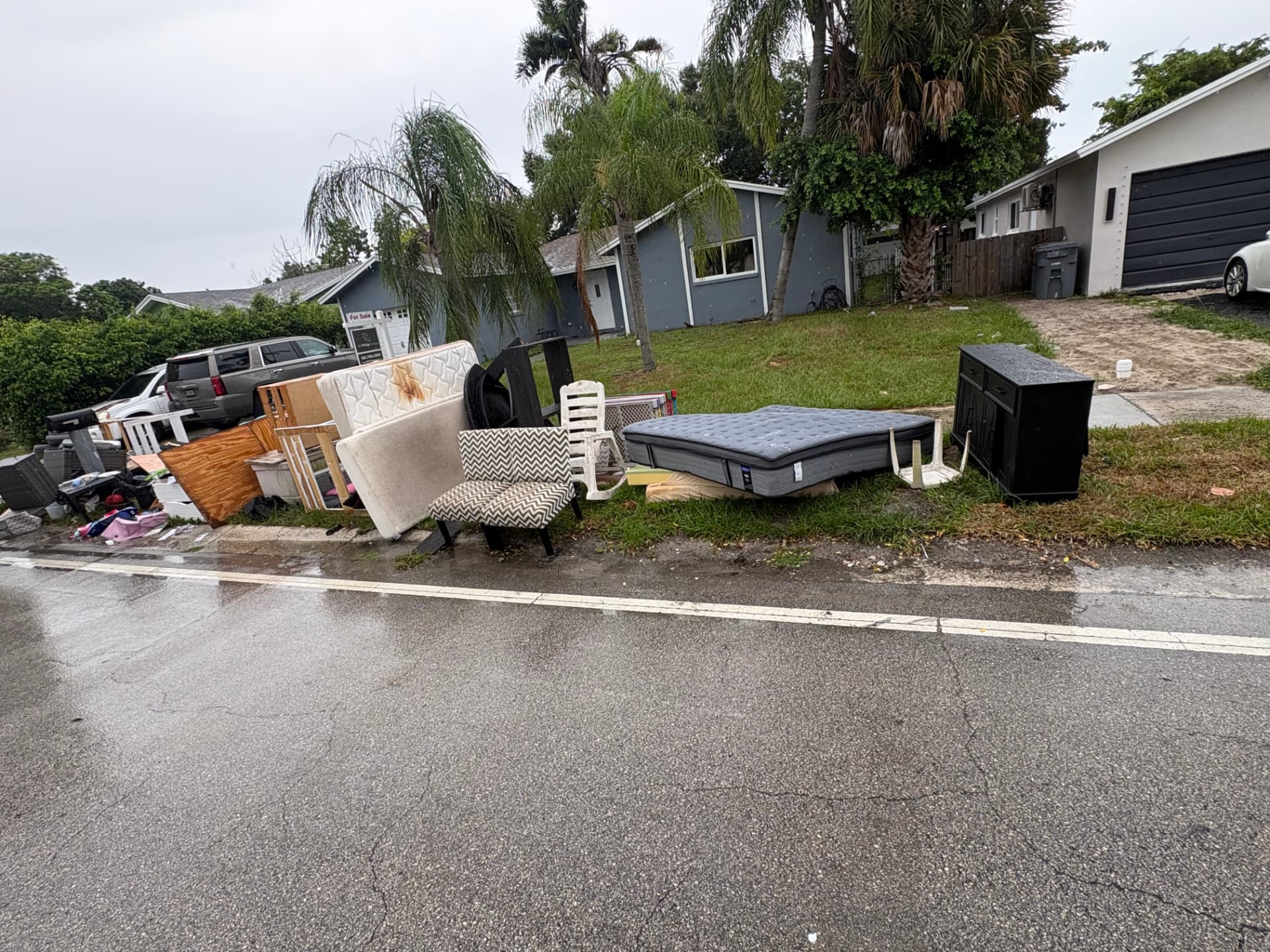 Mattresses, furniture and household items staged outside a property for removal