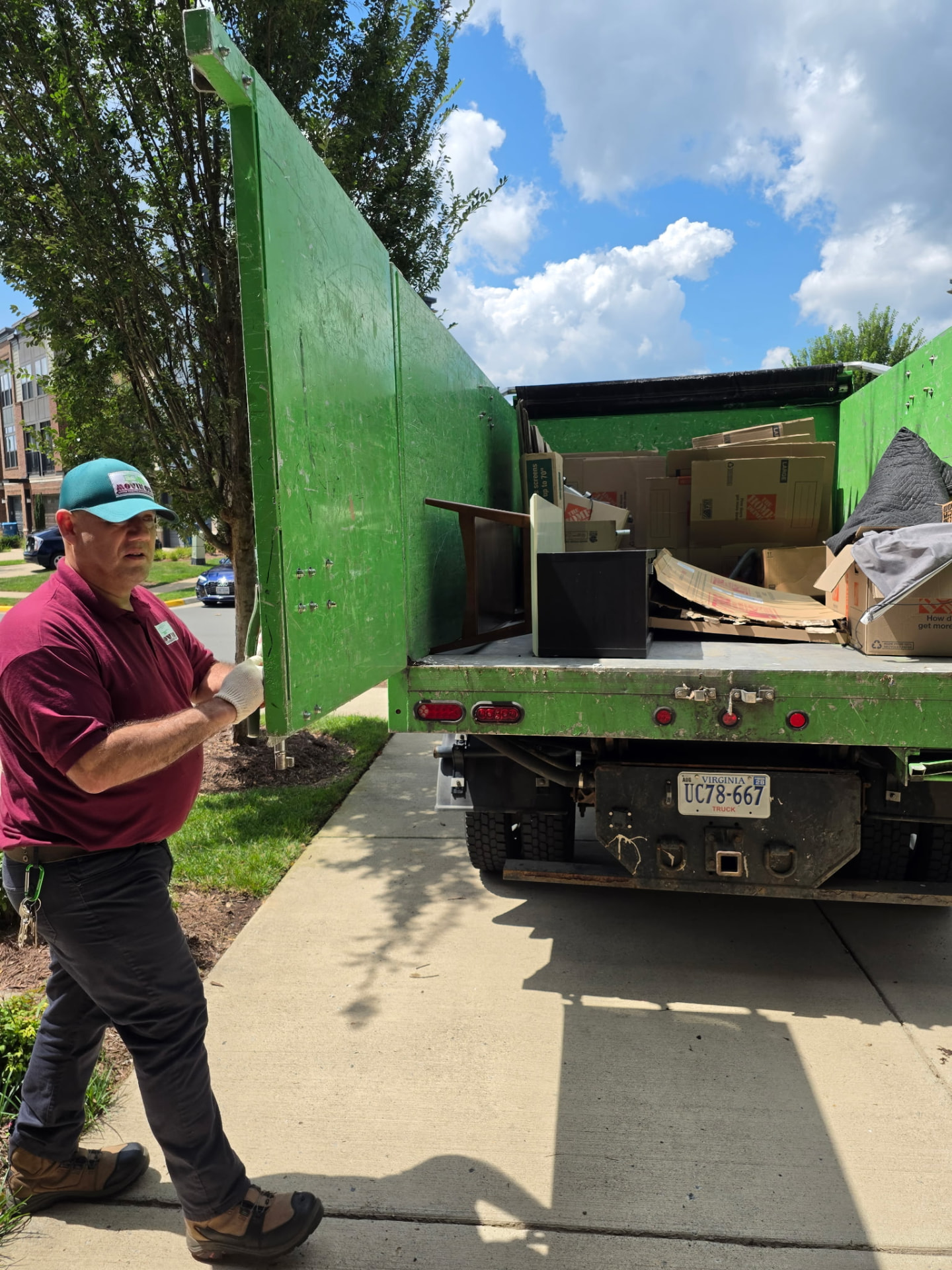 Movin On truck packed with furniture, boxes and household debris on a residential street